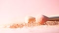 Make up brushes with powder splashes isolated on pink background Royalty Free Stock Photo