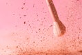 Make up brushes with powder splashes isolated on pink background Royalty Free Stock Photo