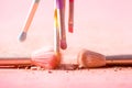 Make up brushes with powder splashes isolated on pink background Royalty Free Stock Photo