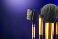 Make-up Brushes set over black holiday blinking background. Various Professional makeup brush on dark backdrop in studio Royalty Free Stock Photo