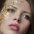 Make-up close-up. Woman`s face, lips, eyes, part. Golden mask. Cosmetics concept