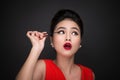 Make-up and cosmetics concept. Asian woman doing her makeup eyelashes black mascara. Royalty Free Stock Photo