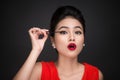 Make-up and cosmetics concept. Asian woman doing her makeup eyelashes black mascara. Royalty Free Stock Photo