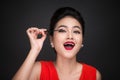 Make-up and cosmetics concept. Asian woman doing her makeup eyelashes black mascara. Royalty Free Stock Photo