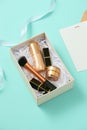 Make up gift box with serum, blush, brushes, cream and lipsticks indoors Royalty Free Stock Photo