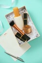 Make up gift box with serum, blush, brushes, cream and lipsticks indoors Royalty Free Stock Photo