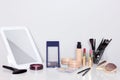 Make-up products with mirror on dressing table. Vanity table with makeup accessories Royalty Free Stock Photo