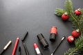 Make-up products and xmas decoration against black background, copy space Royalty Free Stock Photo