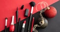 Make-up tools and xmas decoration against red and black background, copy space Royalty Free Stock Photo