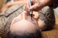 Surabaya indonesia. June 17, 2017. A makeup artist is busy putting on a client`s face