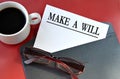 MAKE A WILL - word on white paper lying on a black envelope on a red background Royalty Free Stock Photo