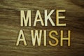 Make a Wish text message on wooden background Royalty Free Stock Photo