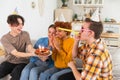 Make a wish. Woman wearing party cap blowing out burning candles on birthday cake. Happy Birthday party. Group of Royalty Free Stock Photo