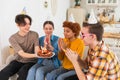 Make a wish. Woman wearing party cap blowing out burning candles on birthday cake. Happy Birthday party. Group of Royalty Free Stock Photo