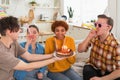 Make a wish. Woman wearing party cap blowing out burning candles on birthday cake. Happy Birthday party. Group of Royalty Free Stock Photo