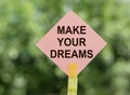 Make your dreams, text a piece of paper on notes on a green background. Concept desire to keep the selected goals and dreams