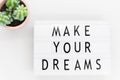 Make your dreams, text written on a lightbox. Decorated with cactus Royalty Free Stock Photo