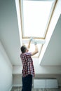 Make your house better. Handyman using screwdriver while fixing or installing a window in a new dry wall attic Royalty Free Stock Photo