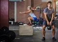 Make your workout count. two people working out with kettlebells in a gym. Royalty Free Stock Photo