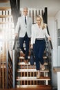 Make yourself at home. two confident businesspeople walking down stairs together while talking inside a building during Royalty Free Stock Photo