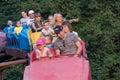 Makeevka, Ukraine - August 11, 2016: People ride on a swing in the city park