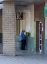 Makeevka, Ukraine - July 30, 2015: Elderly woman near an ATM