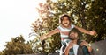 He always makes his little boy feel like a total champion. a father giving his little son a piggyback ride outdoors. Royalty Free Stock Photo