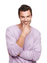 He makes the ladies swoon. A handsome man standing against a white background with his hand on his chin.