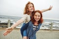 She makes my heart smile. a mother giving her daughter a piggyback ride. Royalty Free Stock Photo