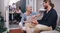 She makes sure every guest is comfortable. a young man and woman chatting at a dinner party with their friends. Royalty Free Stock Photo