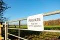 Makeshift private sign seen attached to an entrance to a large farm field. Royalty Free Stock Photo