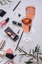 Makeup, accessories and two glasses of sparkling rose on a light background. Cosmetics and fashion blogger background. Fashion Royalty Free Stock Photo