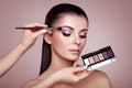 Makeup artist applies eye shadow Royalty Free Stock Photo