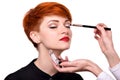 Makeup artist applies eye shadow. Beautiful young woman with short red hair. Makeup detail Royalty Free Stock Photo