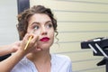 Makeup artist applies eye shadow Royalty Free Stock Photo