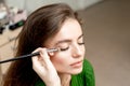 Makeup artist applies eyeshadow on eyes Royalty Free Stock Photo