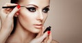 Makeup artist applies eyeshadow Royalty Free Stock Photo