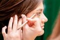 Makeup artist applies eyeshadow powder Royalty Free Stock Photo