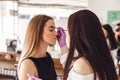 Makeup artist applies paint henna on eyebrows in a beauty salon Royalty Free Stock Photo