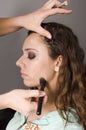 Makeup artist applying base foundation to model Royalty Free Stock Photo