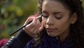 Makeup artist applying eyeshadow on eyes of model or actress, beauty blog Royalty Free Stock Photo