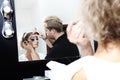 Makeup artist applying mascara on eye lashes of model Royalty Free Stock Photo