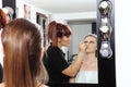 Makeup artist applying mascara on eyes of model