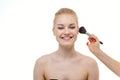 Makeup artist applying powder for beautiful young woman on white background Royalty Free Stock Photo