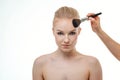 Makeup artist applying powder for beautiful young woman on white background Royalty Free Stock Photo