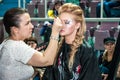 Makeup artist bring make-up girl.