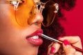 Makeup artist with a brush paints the lips Royalty Free Stock Photo