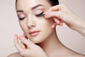 Makeup artist glues eyelashes Royalty Free Stock Photo