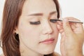 Makeup artist glues eyelashes on client Royalty Free Stock Photo