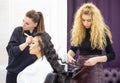 Makeup artist and hairdresser work with beautiful young girl in beauty salon